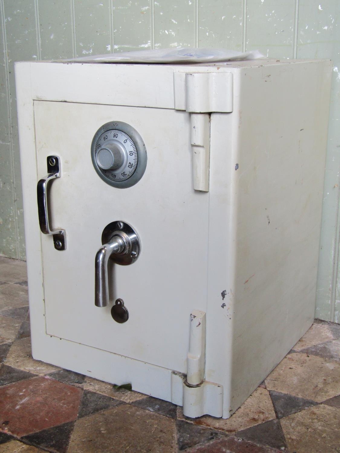 A combination safe and key entry enclosed by single door, possibly by Chubb, together with