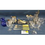 An elegant octagonal based claret jug with a scrolled handle, ten gilded liqueur glasses, four