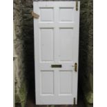 A good quality painted hardwood front door with fielded panels and polished brass fittings, (