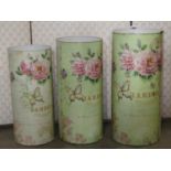 A graduated set of three tin cylindrical waste paper bins/vessels with decorative overlaid decoupage