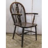 A Windsor stained elm and beechwood hoop and stick back open armchair with pierced wheel back over a