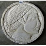 A carved natural stone roundel/portrait plaque, male character, 34cm diameter