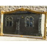 A large contemporary antique style wall mirror with rectangular gilt arched frame, with foliate