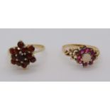 9ct ruby and garnet cluster ring with scrolled shoulders, together with a further 9ct garnet cluster