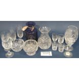 A quantity of 20th century cut glass champagne flutes, wine glasses, and some Waterford and