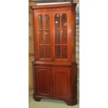 A reproduction Georgian style freestanding two sectional corner cabinet enclosed by two pairs of