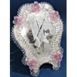 A Venetian glass toilet mirror with pink petal detail to beaded and scrolled glass frame enclosing