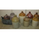 A collection of 19th century stoneware flagons to include a two gallon salt glazed example stamped