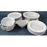 A collection of Wedgwood blue ground china dinner and table wares with embossed low relief white