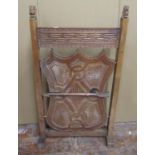 A late 19th century oak firescreen, the side shield shaped central panel with geometric detail,