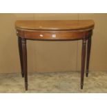 A Georgian mahogany D end fold over top tea table with reeded outline and further reeded supports 90