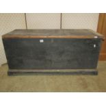 A 19th century dark stained pine blanket box with hinged lid, exposed dovetail construction and