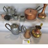 A mixed selection of brass and copper ware, jugs, bowls, saucepan, tea pots, a coffee grinder, loose