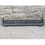 A Victorian cast iron fender with repeating pierced grille and foliate detail, 136cm wide,