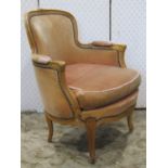 A salon chair with shaped carved and moulded beechwood frame enclosing an upholstered seat and