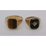 Two 9ct rings; a tigers eye example, size X and an onyx example, size N/O (onyx af), 10.6g total