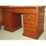 A Victorian mahogany kneehole twin pedestal desk with rectangular leather inset writing surface over