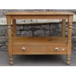 A Victorian stripped pine washstand on two tiers, the lower incorporating a shallow drawer, together