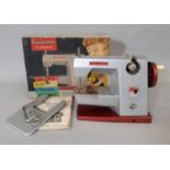 Vintage child's sewing machine 'Vulcan classic' with instructions, extension work table and clamp,