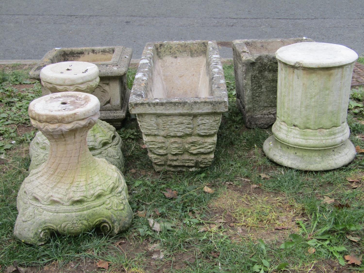 Three weathered cast composition stone planters of various size and design, one with gothic