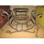A steel cradle shaped log basket, a further ironwork stand of oval form, a collection of 19th
