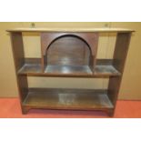 An arts and crafts oak wall mounted book shelf on two tiers with central arch, 60cm wide