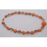Polished coral and smoky quartz bead necklace interspersed with small diamond set white metal beads,