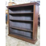 A Victorian mahogany floorstanding open bookcase with three adjustable shelves set on a platform