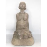 A carved stone statue of a kneeling naked woman , circa 1920’s, 43cm tall x 23cm.