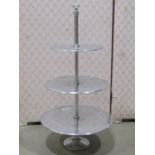 Four contemporary three tier graduated cast alloy cake stands, 61 cm high, together with an entrée
