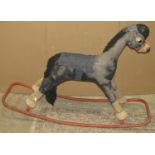 A vintage Merrythought child's rocking horse, plush fabric covered and mounted on a painted