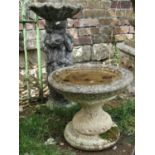 Three weathered cast composition stone birdbaths of varying design, 66 cm and 36 cm in height