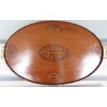 An Edwardian oval mahogany tray with a raised wavy edge and brass handles 65cm x 41cm, together with