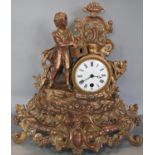 A Victorian gilded brass mantle clock in the romantic style enclosing a single train French movement
