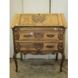 A late 19th century French stripped oak bureau with carved C scroll and moulded detail, the fall