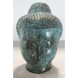A bronze verdigris head of Buddha 14cm high.