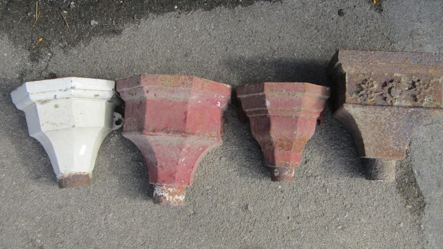 Four weathered cast iron drain water hoppers of varying size and design, one with floral relief