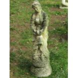 A weathered cast composition stone garden ornament in the form of a standing maiden releasing a