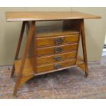 An arts and crafts oak sheet music cabinet, the central tower of four drawers set within four