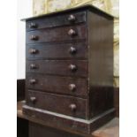 A small Victorian stained pine apprentice table top chest of six long graduated drawers with