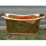 A copper double ended roll top bath with centralised plug hole and fittings, approx 170cm long x
