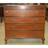 A reproduction Georgian style chest of four long graduated drawers with brush slide on short