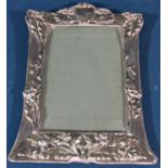 An Edwardian Art Nouveau floral silver photo frame, Chester 1905, maker Boots Pure Drug Company,