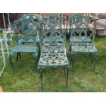 Seven (5&2) green painted cast aluminium garden terrace chairs with scrolling foliate detail,