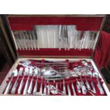 An oak canteen of Community stainless steel cutlery, near complete for twelve settings plus some