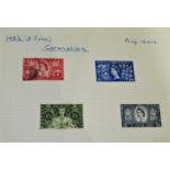 A GB QEII Mint and Used stamp collection in six red Senator albums