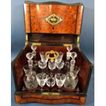 A Victorian burr walnut travelling drinks cabinet with four floral etched glass decanters, six small