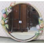 A vintage circular wall mirror with bevelled edge plate within a painted frame, with trailing