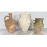 An earthenware flagon, a double handled vase, and a partially glazed earthenware vase.