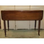 A Victorian mahogany Pembroke table fitted with a frieze drawer raised on turned bobbin legs with